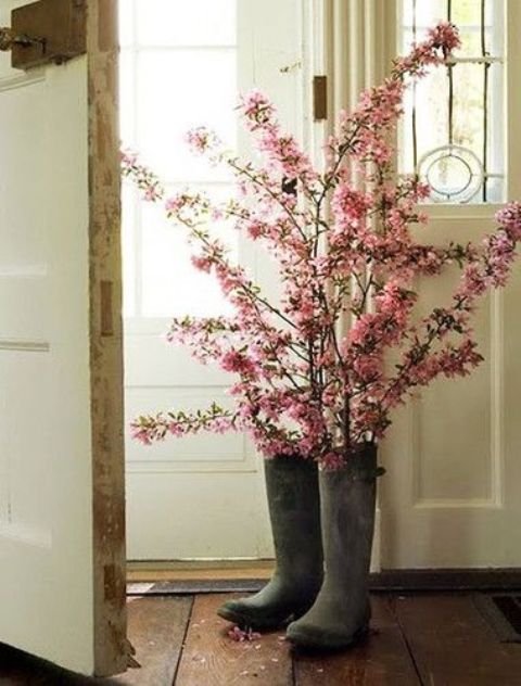 tall rubber boots with pink cherry blossom is a lovely idea for a spring space, it will bring a strong rustic and sprign feel to outdoors or indoors