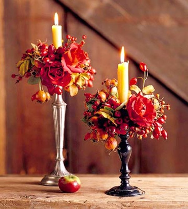 Lovely and refined Thanksgiving or fall decor   vintage candleholders with candles, bold blooms and berries is a lovely idea