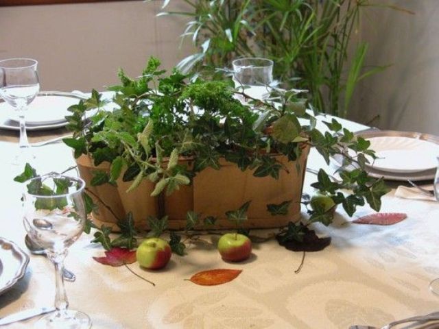 A plywood box filled with various types of greenery is an easy all natural Thanksgiving centerpiece to make