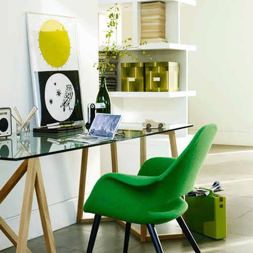 green boxes and an artwork plus a bright green chair bring a spring-like feel to the home office