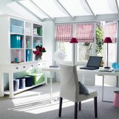 bright striped Roman shades and bright blue touches make this neutral home office super bright and spring-like