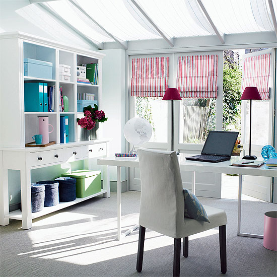 Bright striped Roman shades and bright blue touches make this neutral home office super bright and spring like