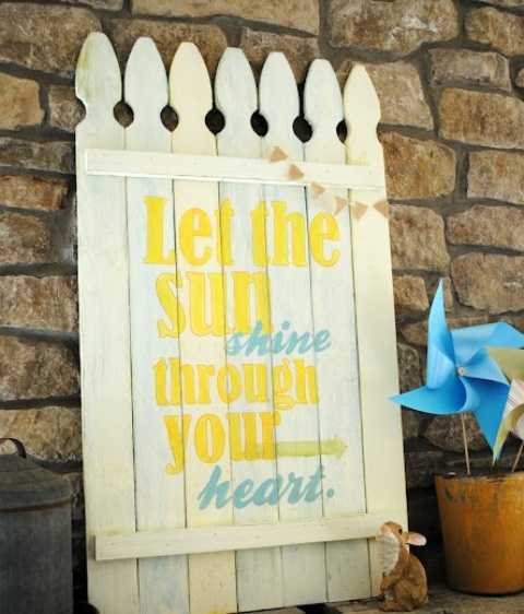 A bold rustic sprign sign in white with blue and yellow letters feels and looks very spring like
