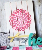 a simple and cute soring sign with a pink bloom stenciled plus some ribbons is a lovely idea for spring or summer