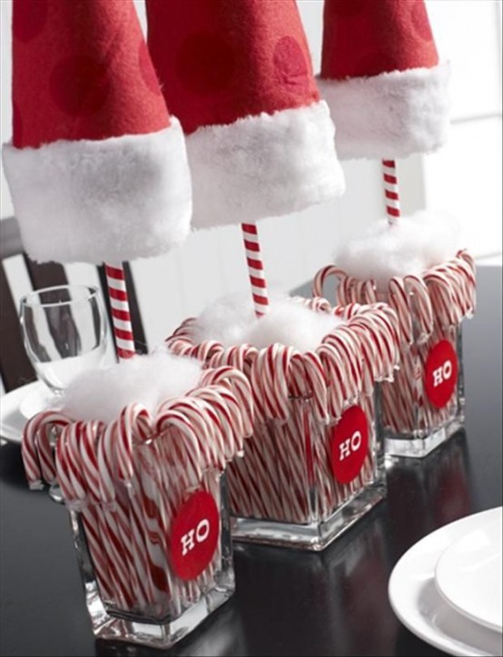 bold and pretty Christmas decor of vases with candy canes, faux snow and large Santa hats is a very fun and whimsical idea to rock (check out this DIY tutorial on diycandy)