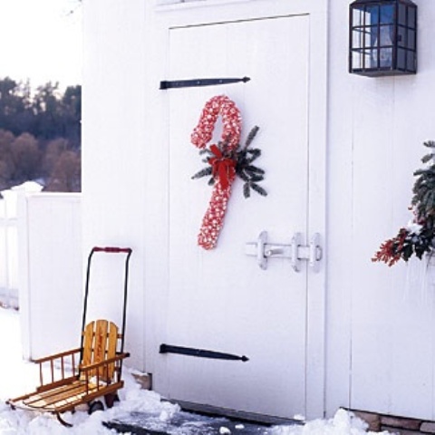a bright red and white ribbon candy cane wreath will accent your door at its best and will make your space whimsical and fun