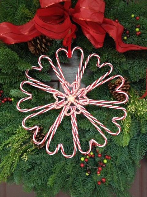 A cute candy cane heart shaped wreath for Christmas with a large red bow is a lovely decoration for Christmas you can DIY anytime