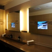 large lit up mirrors with built-in TV screens are a very cool solution if you love watching something and don’t want to stop watching while being in the bathroom