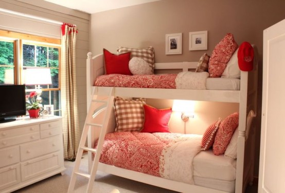 a tiny and cozy white bunk bed unit with a ladder and a single wall lamp over the lower bed for a welcoming bedroom