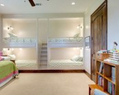kids’ bunk bed units for four, with wall sconces and a single ladder between the bed blocks