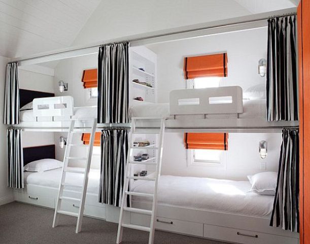 A functional kids' bunk bed setup done in white, greys and with orange accents, with ladders and lights