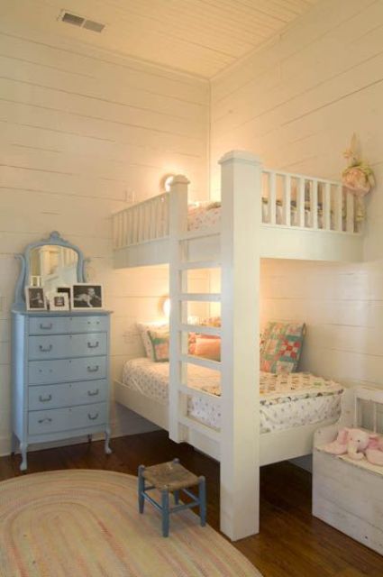 Vintage built in white bunk beds, wall sconces and an integrated ladder to go to the upper part