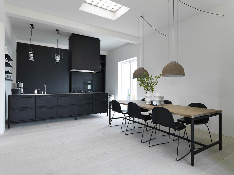 modern kitchen with black cabinets and a black backsplash
