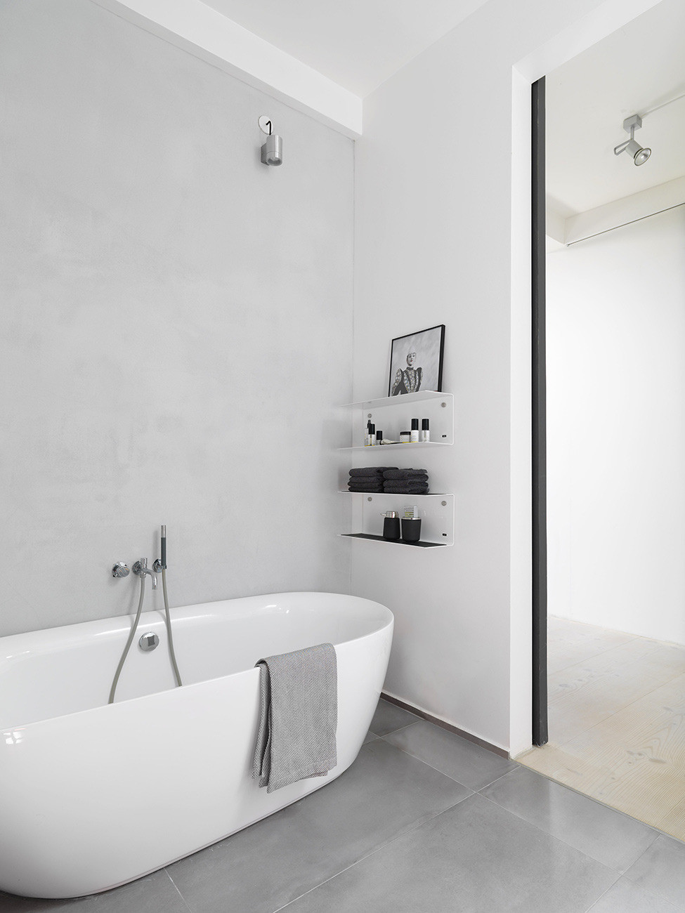 almost pure white bathroom with minimalist looking open shelving