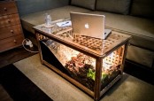 an IKEA Hol table transformed into a turtle terrarium with light, it doubles as a coffee table in the living room