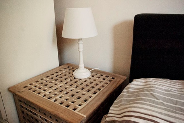 A small IKEA Hol nightstand   use the space inside for storage and place a lamp on top