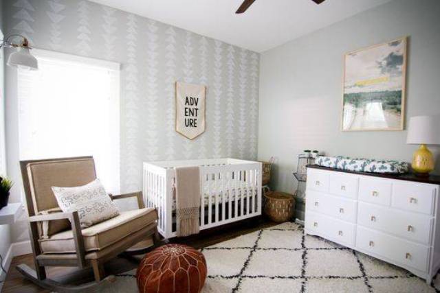 A neutral mid century modern nursery with elegant furniture, a leather ottoman, signs and artworks is a very cozy and welcoming space