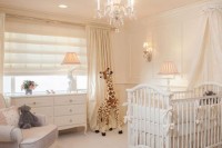 a gender-neutral and neutral nursery with vintage glam touches, a crib with ruffles, a glam vintage chandelier, curtains and shades and some pretty toys
