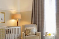 a welcoming and cozy neutral nursery with color block walls, touches of tan, yellow and taupe curtains, lamps that match