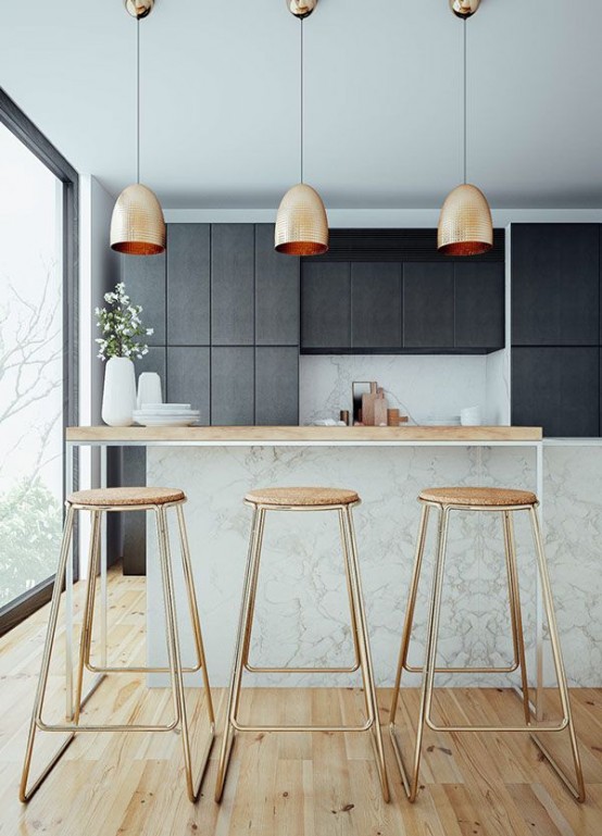hammered gold pendant lamps and tall gold stools with cork seats make this moody kitchen brighter, cooler and more glam-like
