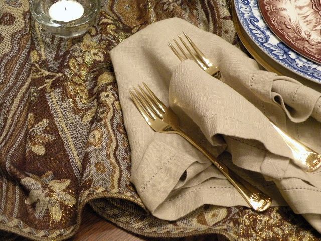 Gold cutlery, neutral textiles, patterned plates for a vintage inspired Thanksgiving place setting