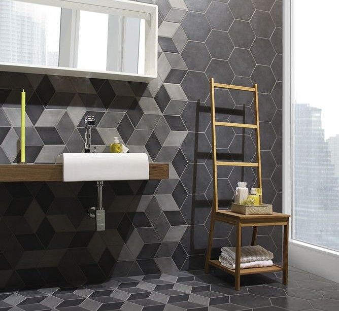 A contemporary dark colored bathroom with geometric tiles, hexagons with color blocking and without looks amazing