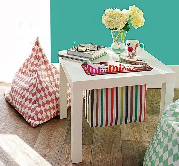 An IKEA Lack table with a built in striped sack for storing newspapers is a gorgeous idea for a modern living room, and a fun touch of color