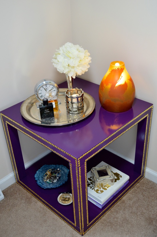 A couple of Lack tables made over into a unique and colorful coffee table with a lower shelf, done in bold purple and with decorative nails   such an IKEA hack just wows