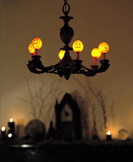 a chandelier with mini pumpkins on top looks cool and cute and will fit a Halloween space
