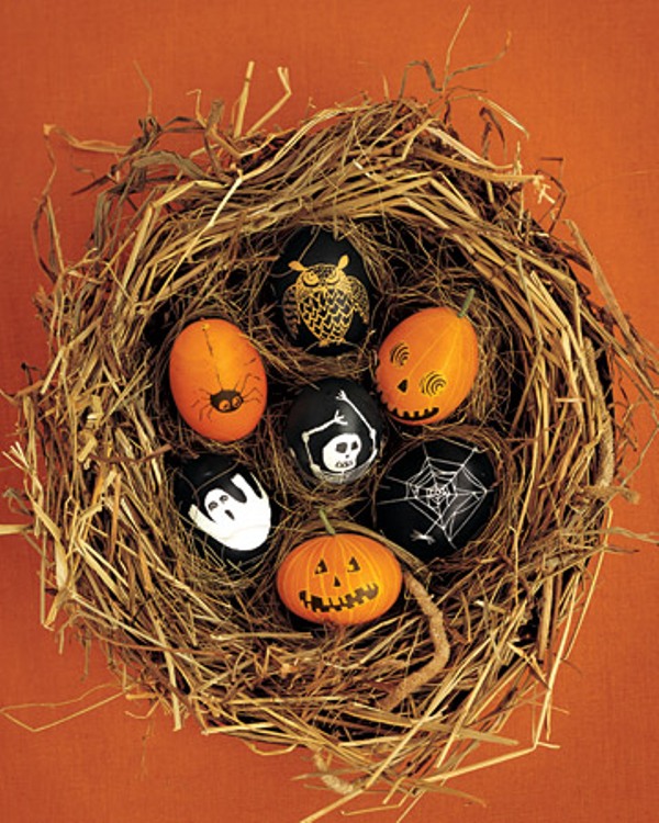 A nest with eggs that are painted as scary Halloween pumpkins is a very creative decoration for Halloween