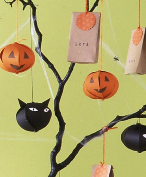 branches with paper black cats and jack-o-lanterns are great for decorating a space for Halloween