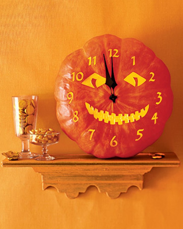 A pumpkin with a painted face and a clock is a cool solution for Halloween decor and parties