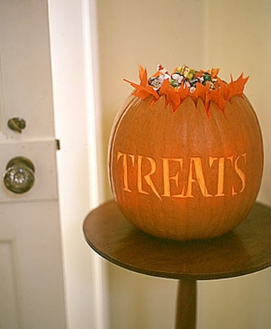 cut out a pumpkin and place candies inside, it's a truly Halloween-like decoration