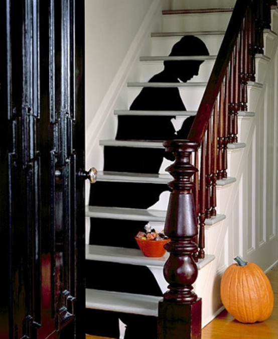 a scary Halloween silhouette attached to the staircase is a lovely idea for Halloween