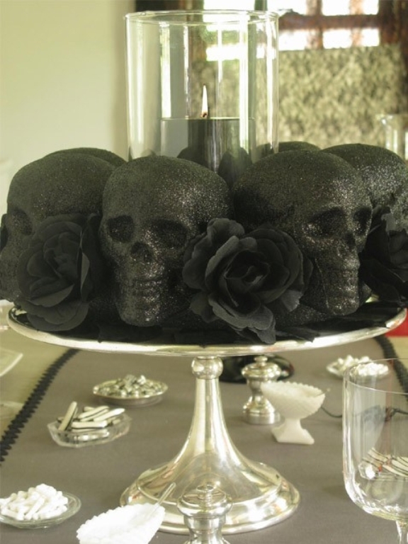 A metallic dish with black skulls and black blooms is a simple last minute decoration for Halloween