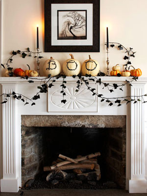 Draw the letters B-O-O on a trio of pumpkins using a black marker. You can use them as a centerpiece of your mantel's decor.