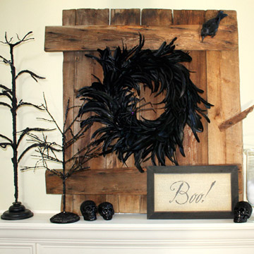 A bunch of rustic wood boards with a black wreath on them could become a great addition to your living room's Halloween decor.