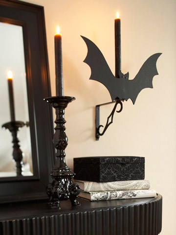 Attach black cardboard bat silhouettes to your wall lights.