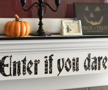 A spooky decal from your local crafts store and apply to a smoothly painted surface. It'd be easy to peel off later.