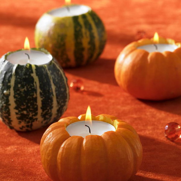 Gourds and pumpkins carved to hold candles are cool for natural and cozy Thanksgiving decor or just for fall