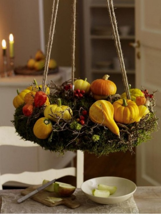 a rustic chandelier of moss, with berries, gourds and dried blooms is a cool decoration you can DIY