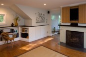 a fireplace with a TV over it and sliding doors covering the TV are a lovely combo for a modern space
