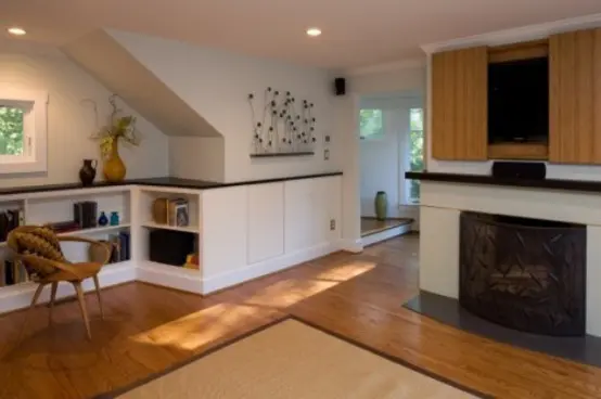 a fireplace with a TV over it and sliding doors covering the TV are a lovely combo for a modern space
