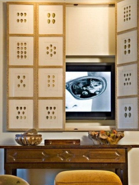 a TV hidden with a small gallery wall of artwork is a cool idea for a modern space, and the artworks can be different
