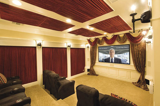 an elegant home theater designed as a real theater, with all neutral everything, burgundy curtains and dark brown sofas and chairs is all cool