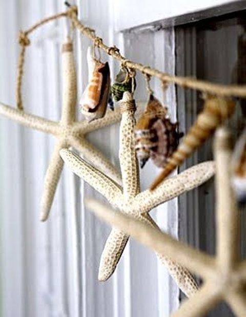 a catchy twine and seashell and starfish garland can be hung anywhere - on the window, on a shelf or wherever else you want