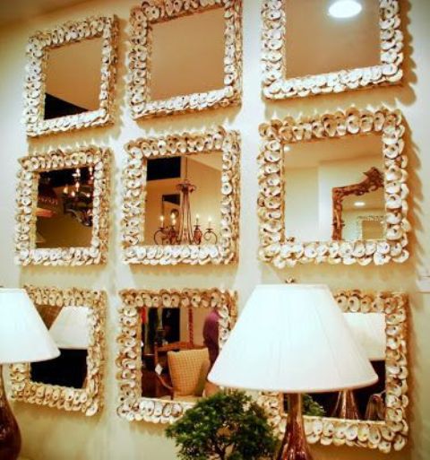 a whole gallery wall of mirrors clad with small seashells is a great idea for an entryway or some other space