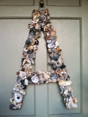 accent your front door with a large monogram made of seashells – a perfect idea for a coastal home or for summer