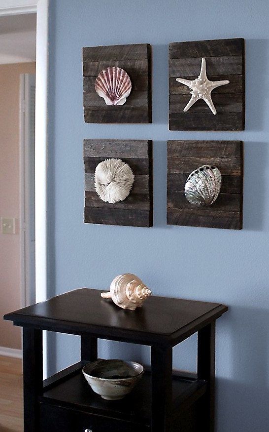 Reclaimed wooden plaques with starfish and seashells make up a cool sea inspired and coastal inspired gallery wall