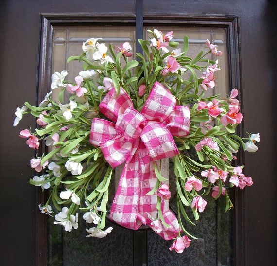 A fresh pink bloom wreath with a pink plaid bow is a bold summer like decoraiton for your front door